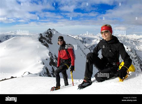 Two Climbers Resting On The Mountain Peak South Tyrol Trentino Alto