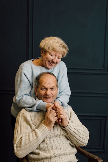 Premium Photo Portrait Of Old Couple Wife And Husband Hugging And Smiling Dark Blue