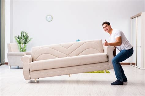 Premium Photo Young Man Moving Furniture At Home
