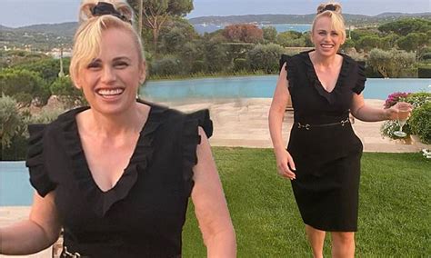 Rebel Wilson Shows Off Her Svelte Figure In A Little Black Dress As She Sips On Champagne In France