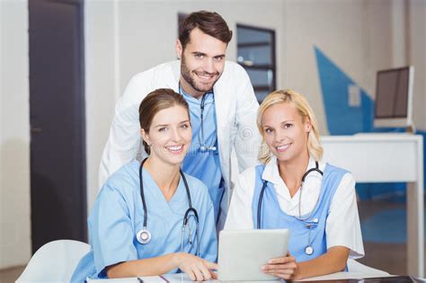 Portrait Of Cheerful Doctor Colleagues With Digital Tablet Stock Image