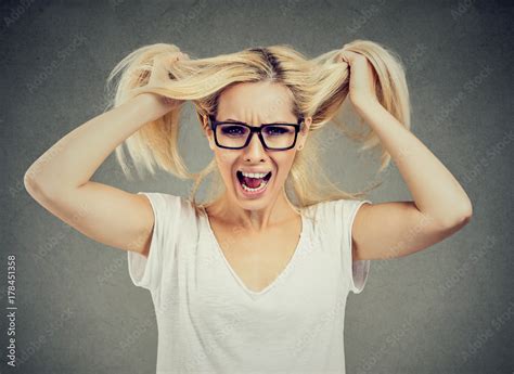 Angry Woman Screaming Out Loud And Pulling Her Hair Out Stock Photo