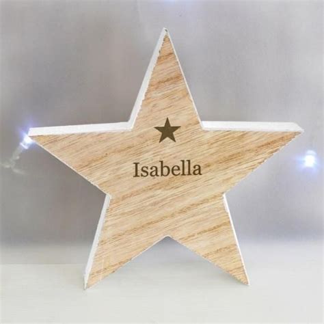 A Wooden Star Ornament With The Name Isabella On It