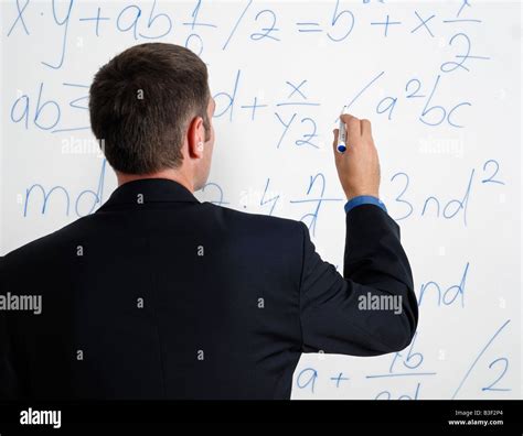 Man Looking At Calculations And Formula On A Whiteboard Stock Photo Alamy