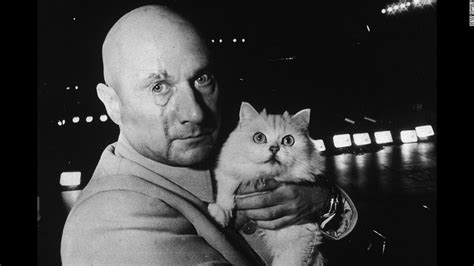Donald Pleasence In Character As Ernst Stavro Blofeld Holding A White