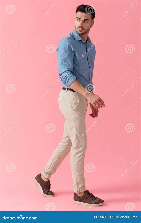 Businessman Walking While Looking Back Over Shoulder Cool Stock Photo