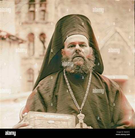 Greek Orthodox Priest At St Catherines Monastery In The Sinai Holding