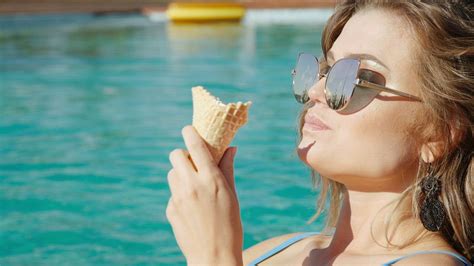 Closeup Of Woman Eating Ice Cream In Swimsuit Free Stock Video
