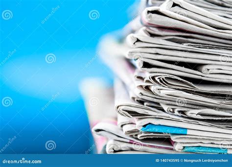 Newspapers Folded And Stacked On The Table With Blue Backgroundcloseup