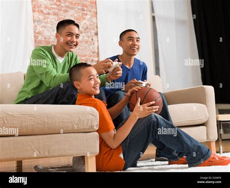 Mixed Race Brothers Playing Video Games Together Stock Photo Alamy