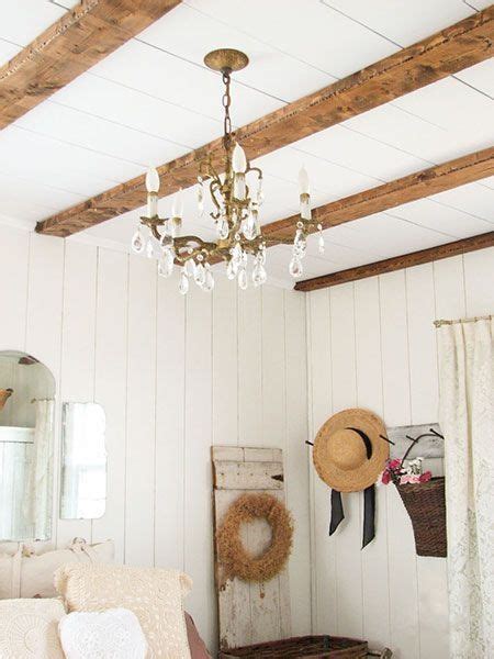 Exposed Distressed Pine Wood Beams Run Across The Ceiling Of This