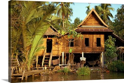 A Traditional Thai House On Stilts Above The River In Bangkok Thailand