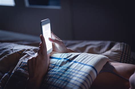 Woman Using Phone Late At Night In Bed Person Looking At Text Messages