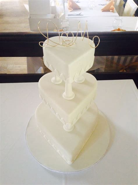 3 Tier Ivory Heart Wedding Cake Separated By Pillars Heart Wedding