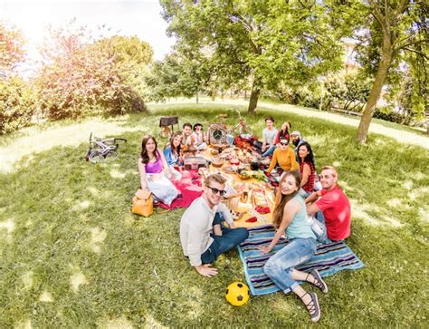 Premium Photo Group Of Happy Friends Making Picnic On Pubblic Park