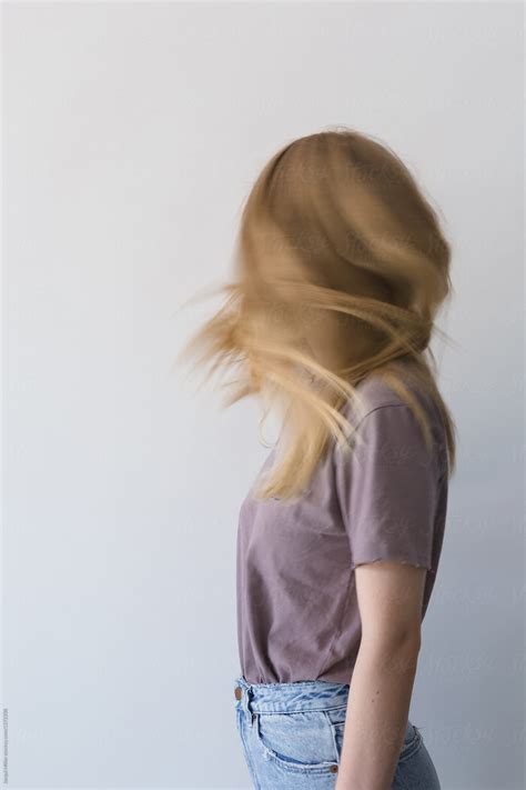 Side View Of Unrecognisable Teen Girl Swishing Her Hair By Stocksy