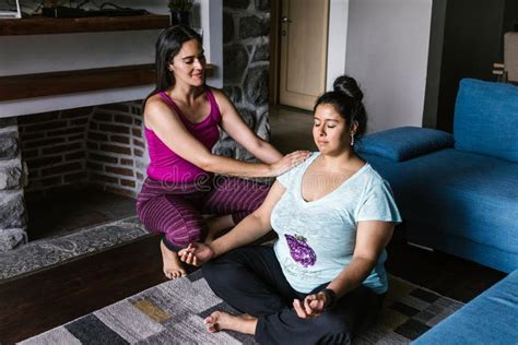 Curvy Hispanic Girl With Instructor Practicing Yoga Poses At Home In