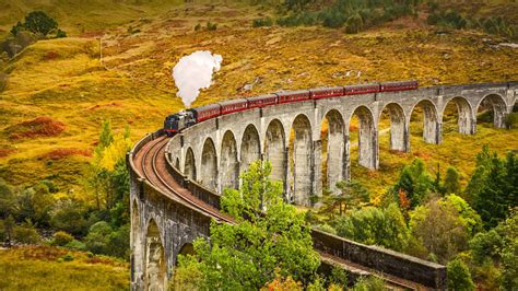 The Jacobite Steam Train Crossing The Glenfinnan Viaduct In Inverness