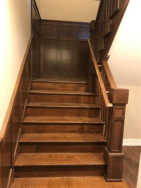 Replaced honey oak railings with a rich dark stained poplar & iron balusters. Craftsman style staircase with wood balusters and wainscot panels - basement view | Wood ...