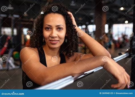 Beautiful Young Smiling African American Woman Looking At Metal Disc On