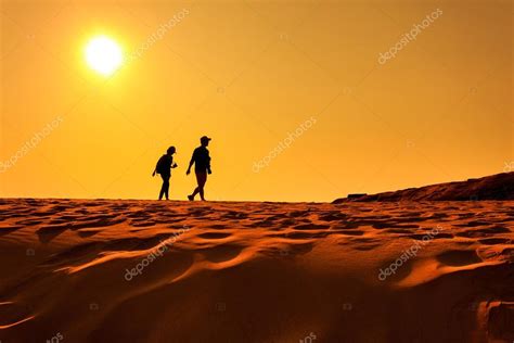 Two People Walking On Sand Desert — Stock Photo © Wittybear 106081100