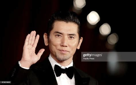 Japanese Actor Masahiro Motoki Poses On The Red Carpet To Present The