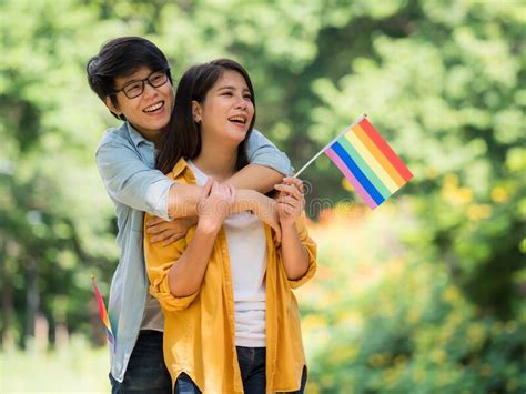 asian couples show the lgbt symbol and embrace each other with love and happiness stock image