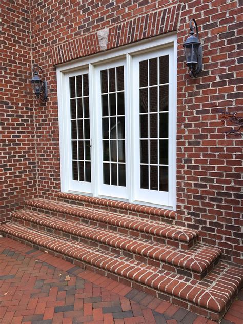 Enclosed In Stately Brick Triple French Doors Exit To A Paved Brick