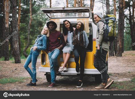 Multiethnic Travelers Near Minivan In Forest — Stock Photo © Alebloshka