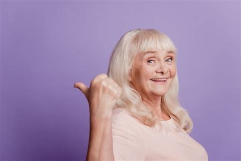 Premium Photo Pretty Sweet Mature Woman Pointing Fingers Empty Space Isolated Purple Background