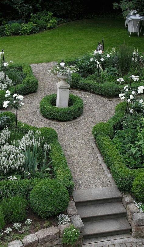 Green And White Formal Garden With Gravel Path And Evergreen Boxwood
