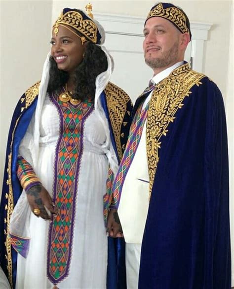 Couple In Habesha Kemis Traditional Attire With Gold Embroidered Robes And Caps For Melsi