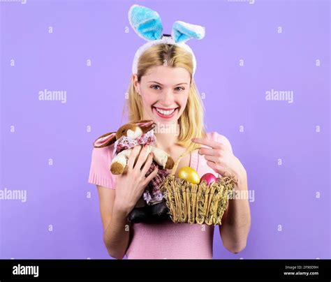 Easter Day Smiling Girl In Rabbit Ears With Basket Eggs And Bunny Toy