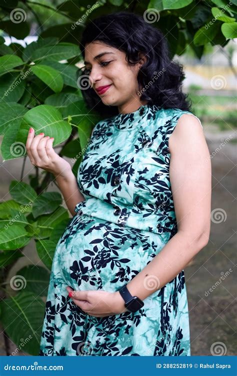 A Pregnant Indian Lady Poses For Outdoor Pregnancy Shoot And Hands On Belly Indian Pregnant