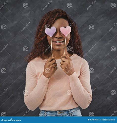 Joyful African Girl Covering Eyes With Valentine Hearts Stock Image