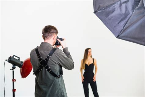 Photographer Taking Pictures Of Model In Studio Free Photo