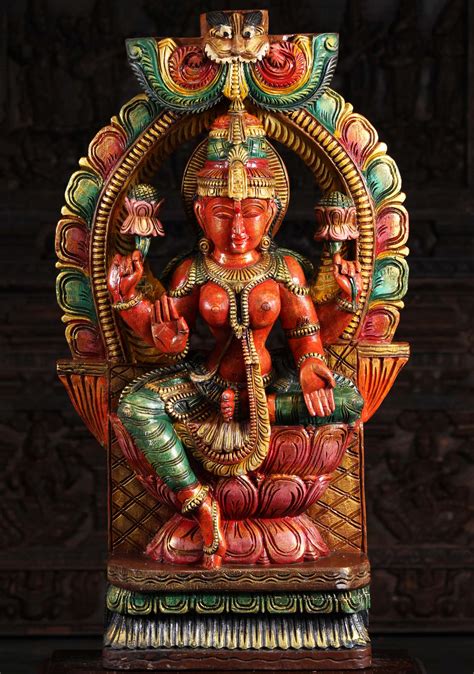 Wooden Lakshmi Holding Lotus Flowers Hand Carved From Neem Tree Wood In South India
