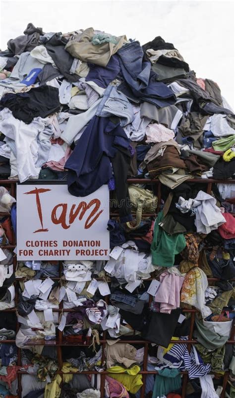 Clothes For Donation Happy Black Couple Holding Clothing And Showing