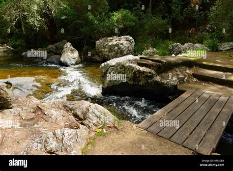 A Small Wooden Bridge Over A Flowing River Granite Bend Track To