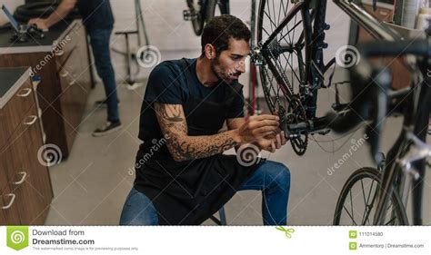 Mechanic Repairing A Bicycle In Workshop Stock Photo Image Of Bicycle