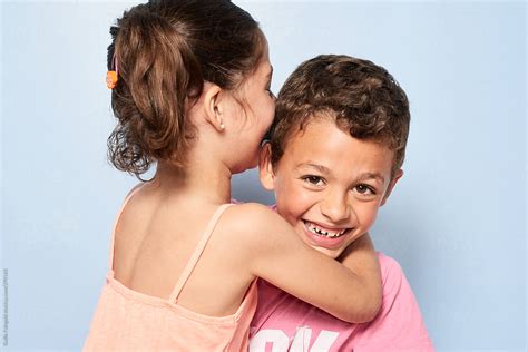 Happy Siblings Hugging Looking At Camera By Stocksy Contributor