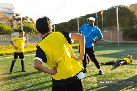 Front View Of A Mixed Race Male Soccer Coach Standing And Instructing A