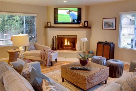 The minas hilaj artwork, floral mind, and geometric candle holders add drama against the. corner fireplace layout 2 - tv over fireplace, ottomans ...
