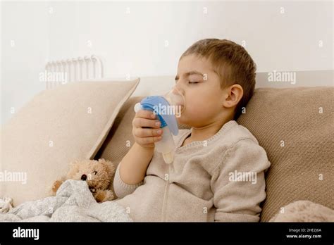 Sick Little Boy With Inhaler For Cough Treatment Unwell Kid Doing