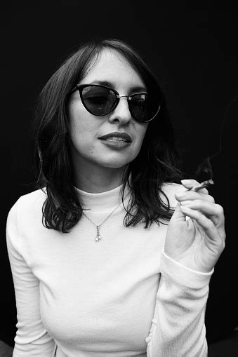 Stylish Woman Smoking A Joint On Black Background Stock Photo