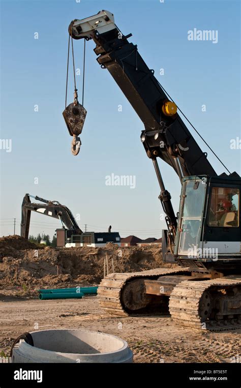 A Mobile Crane And A Hydraulic Excavator At A Construction Site Stock