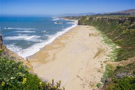 Cliffs And Sandy Beach On The Pacific Ocean Coastline Stock Photo