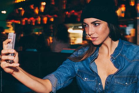 Stylish Woman Taking Selfie In Bar By Stocksy Contributor Guille