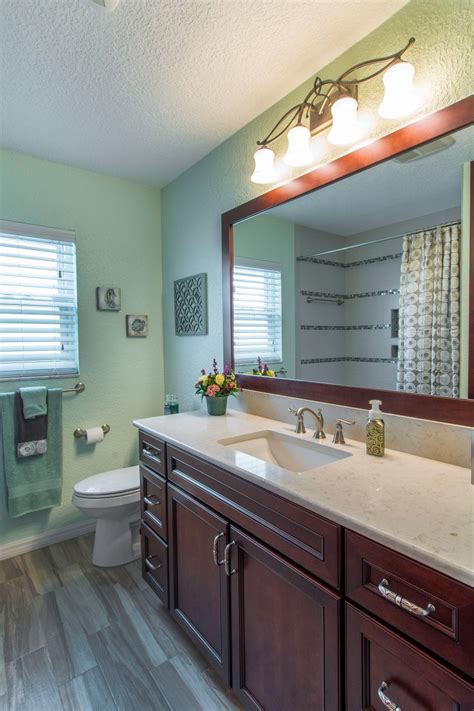 Green Transitional Style Bathroom With Wood Vanity And Mounted Light