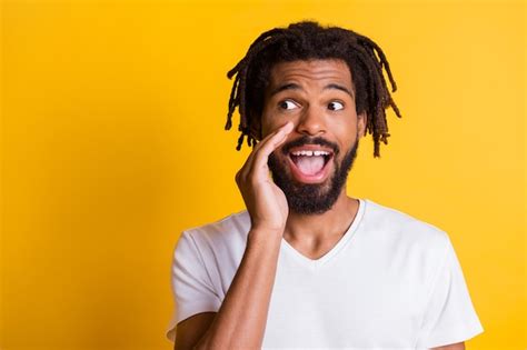 Premium Photo Photo Of Silly Dark Skin Guy Hold Arm Near Mouth Tell